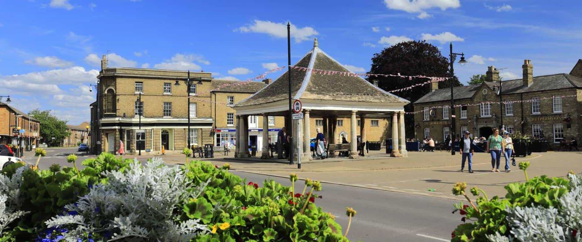 Charming town square in Whittlesey with historic buildings and lively community atmosphere.