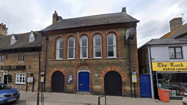 Traditional brick building housing The Whittlesey Charity in a historic town centre.