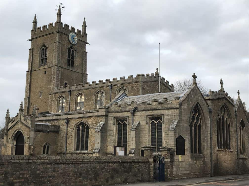 Historic church building in Whittlesey, UK, with Gothic architecture and clock tower.